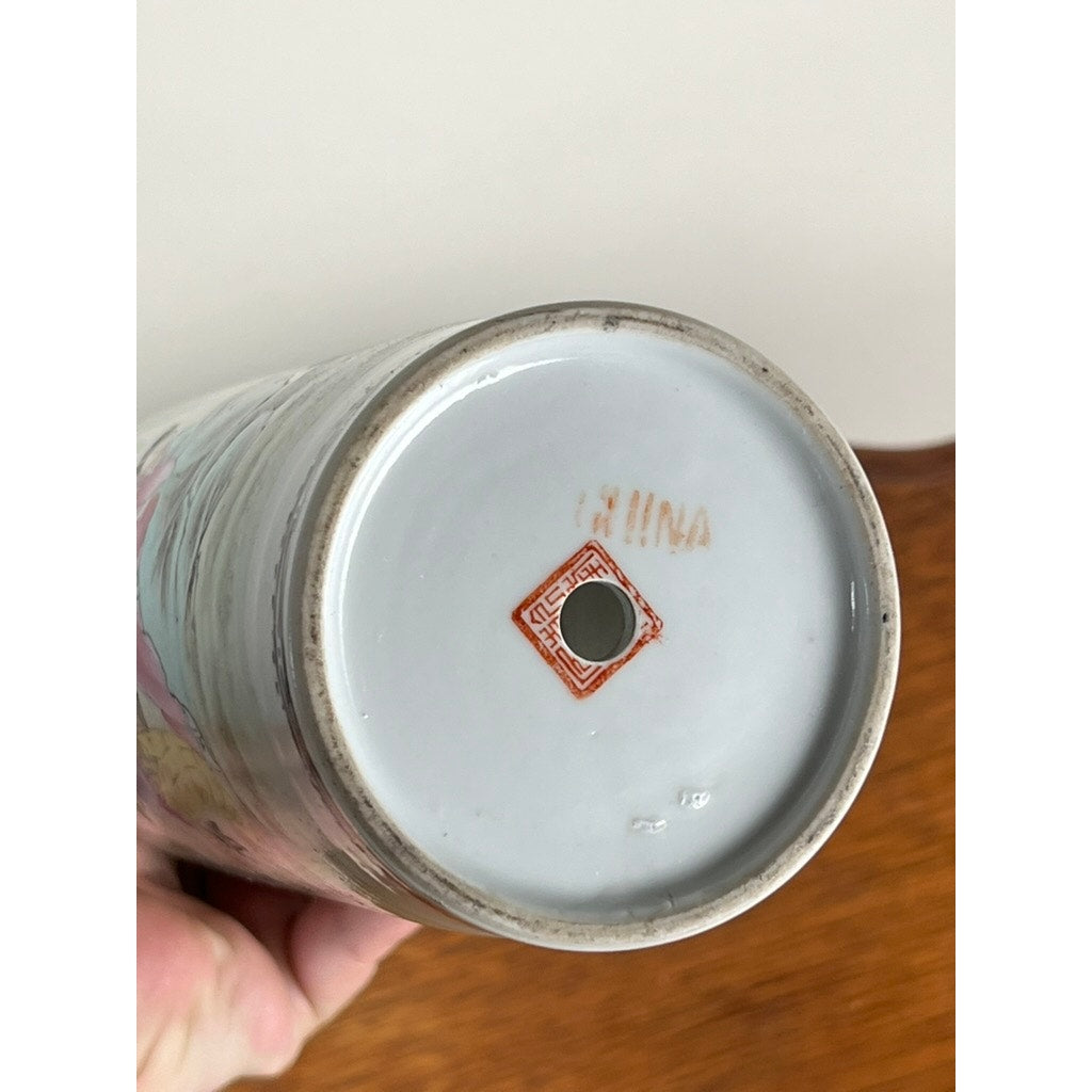 The base of this Antique Qing Dynasty Famille Rose 12” Vase with Qianlong Mark displays a red square stamp with a border, a central hole, and faint orange-brown "CHINA" lettering. The vase is shown held in hand. Brand: Unknown.