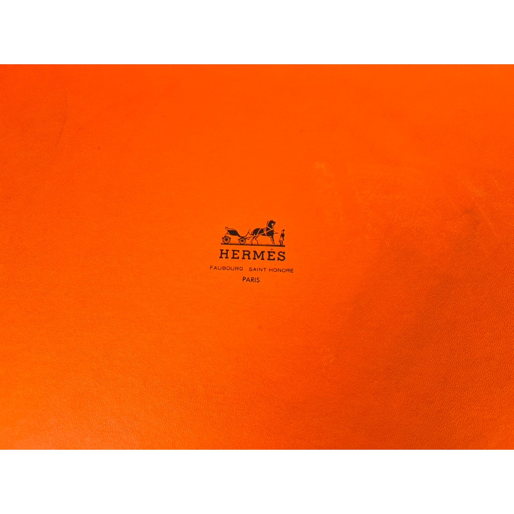 Vivid orange surface with the Hermès logo and horse-drawn carriage—ideal for displaying your Set of Eight Hermès Crystal Champagne Flutes by Saint Louis France 10.5” or other luxury collectible glassware.