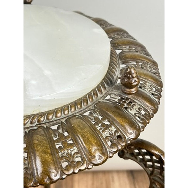 Close-up of an Antique Victorian Bronze and Onyx Stand (late 19th century) featuring intricate bronze detailing, a round white onyx top, ornate edging with a small finial, and a classic bronze finish. Brand: Unknown.