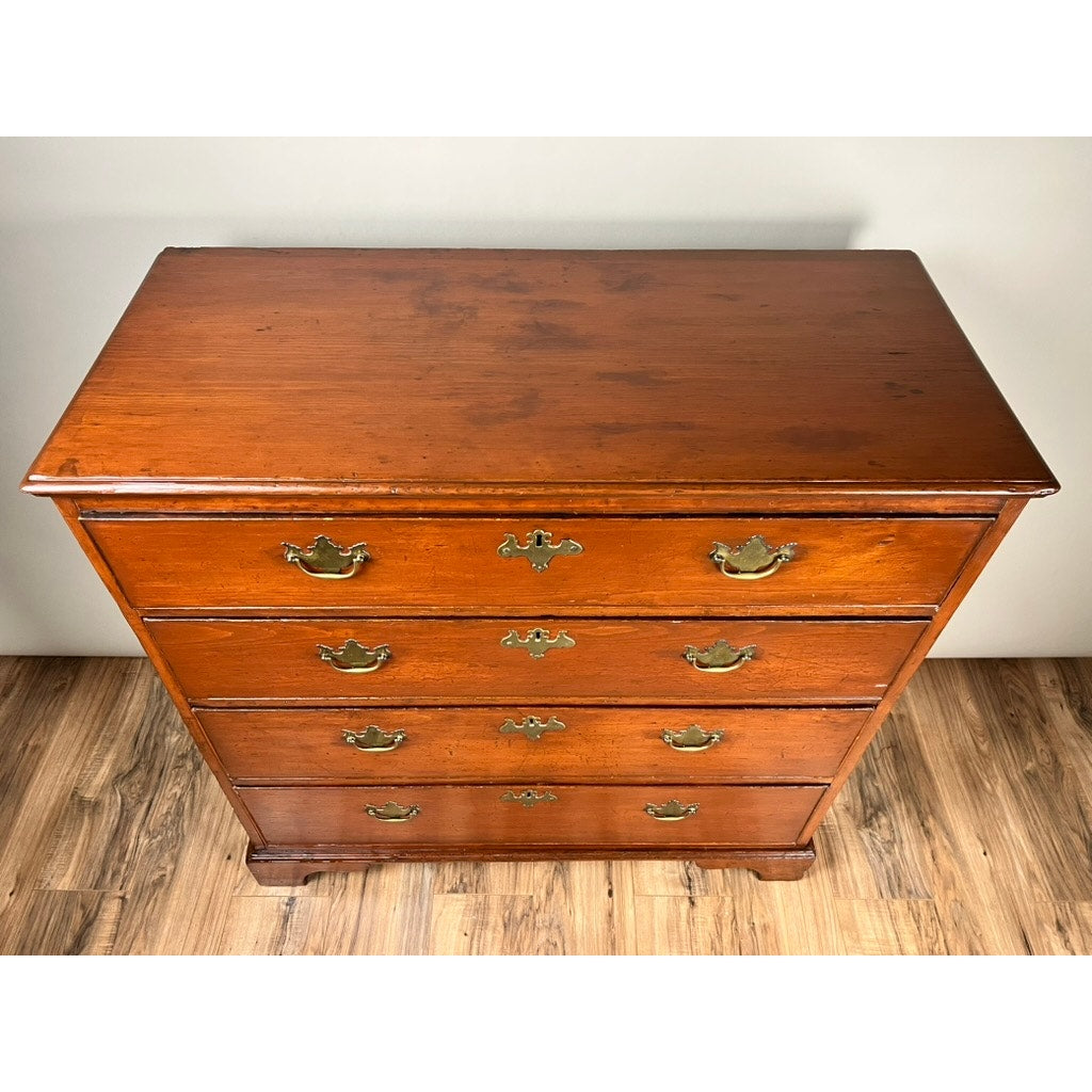 An Antique Chippendale Pine Graduated Four Drawer Chest, c. Late 18th Century (attributed to a Northampton, MA maker), is shown from above with brass handles, on a wood-patterned floor against a light wall. Brand: None/Unknown.