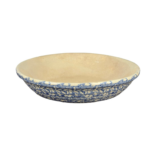The Robinson Ransbottom Roseville Blue Spongeware Pasta Bowl features a textured blue and white exterior with a beige interior, displayed against a white background.