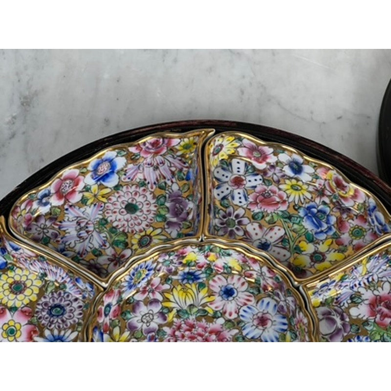 A close-up of a Vintage Chinese Canton Sweet Meat Set (c. Early 20th Century), this porcelain dish is sectioned, each with colorful floral patterns and gold trim, displayed on a light marble surface. Brand: Unknown.