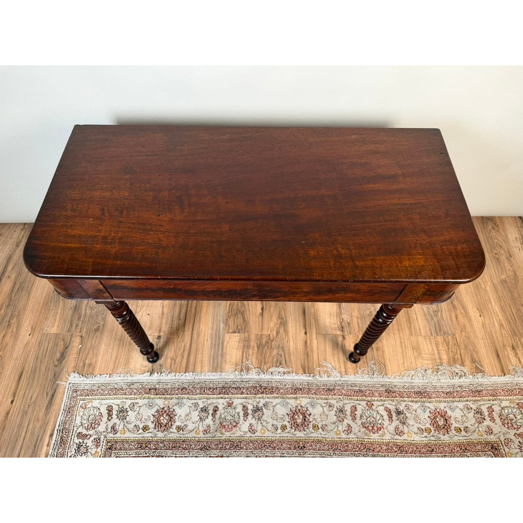 An American Classical Mahogany Single Drop-Leaf Table with spiral-twist legs (c. 1830–1845) from Pearl City Antiques stands on a patterned rug over a light wood floor; its rectangular surface features a polished, dark finish.