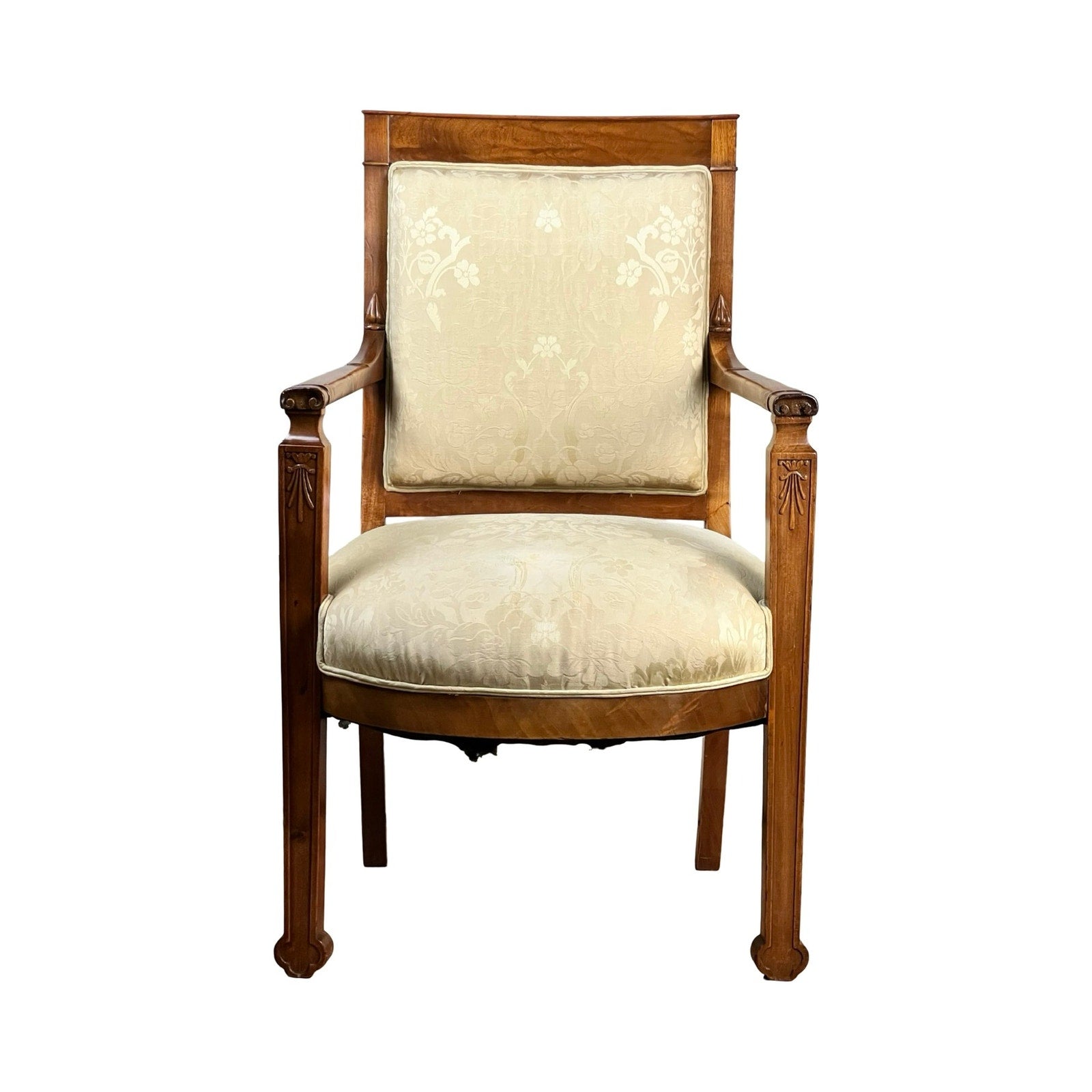 An Antique French Directoire Style Fauteuil Open Arm Chair in Sapelle Mahogany (late 19th c.) features carved details and a light cream floral-patterned upholstered backrest and seat, shown against a white background. Brand: Unknown.