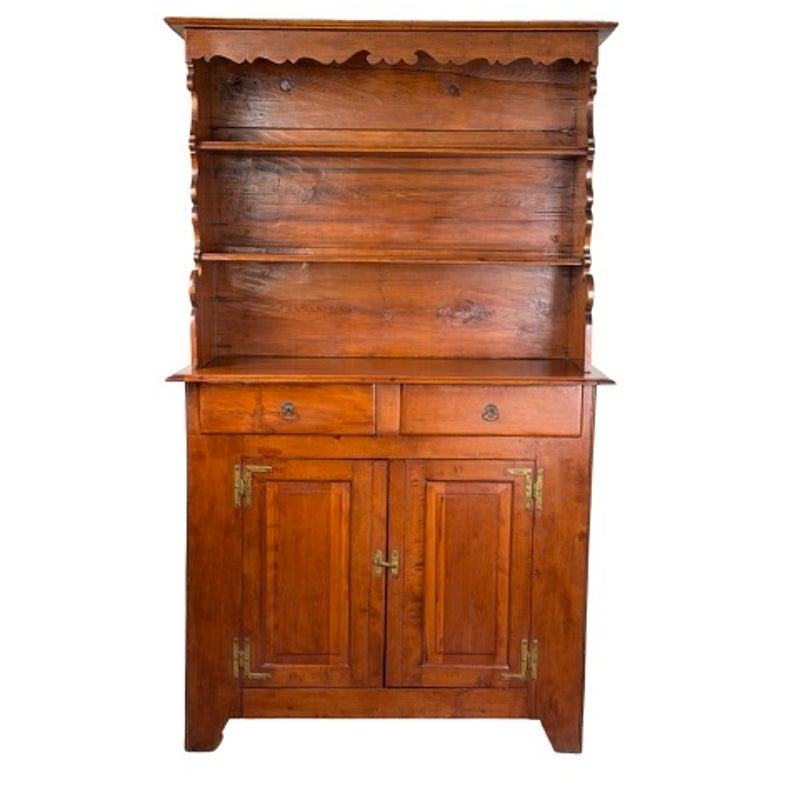 Pennsylvania or Mid-Atlantic Cherry Open Pewter Cupboard, circa 1800–1830, featuring an open three-shelf top, two drawers, and a lower cabinet with two paneled doors and brass hinges.