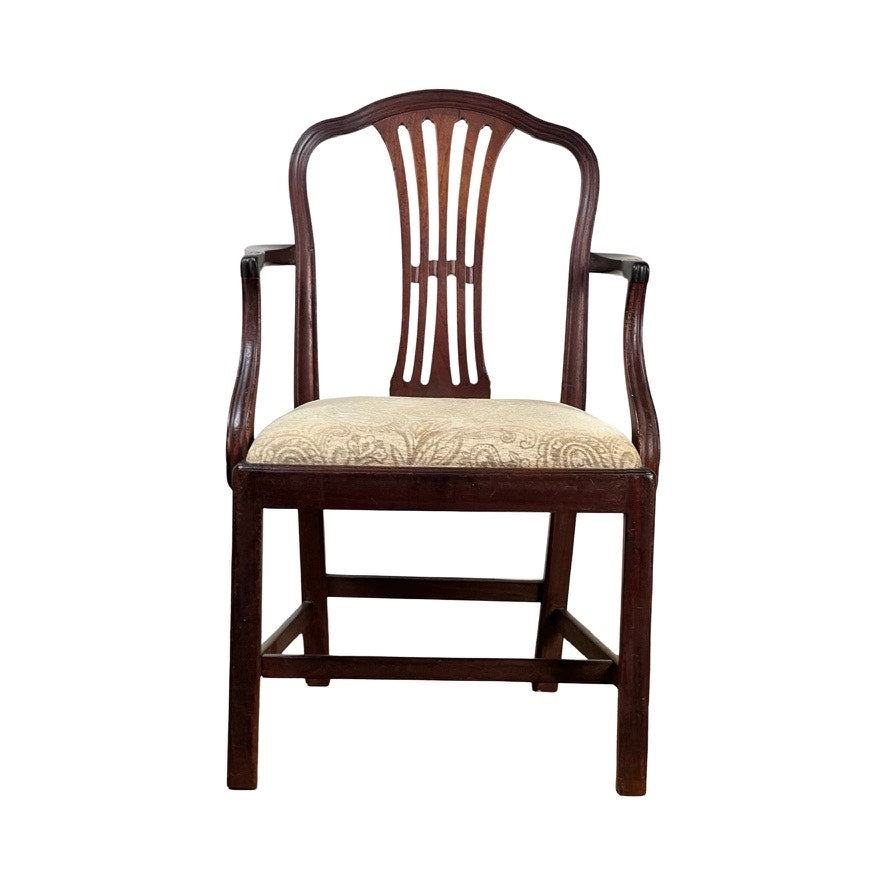 Front view of an Antique English George III Mahogany Hepplewhite Armchair (early 19th century) with a decorative backrest and upholstered beige patterned seat, isolated on a white background.