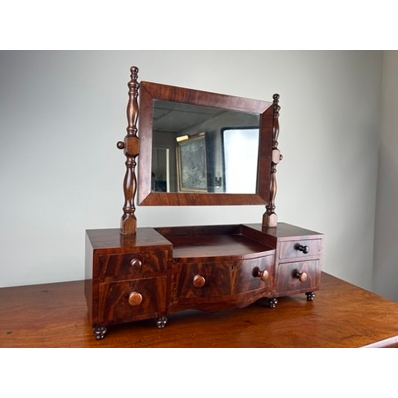 Early 19th century drop center shaving mirror with drawers and turned supports