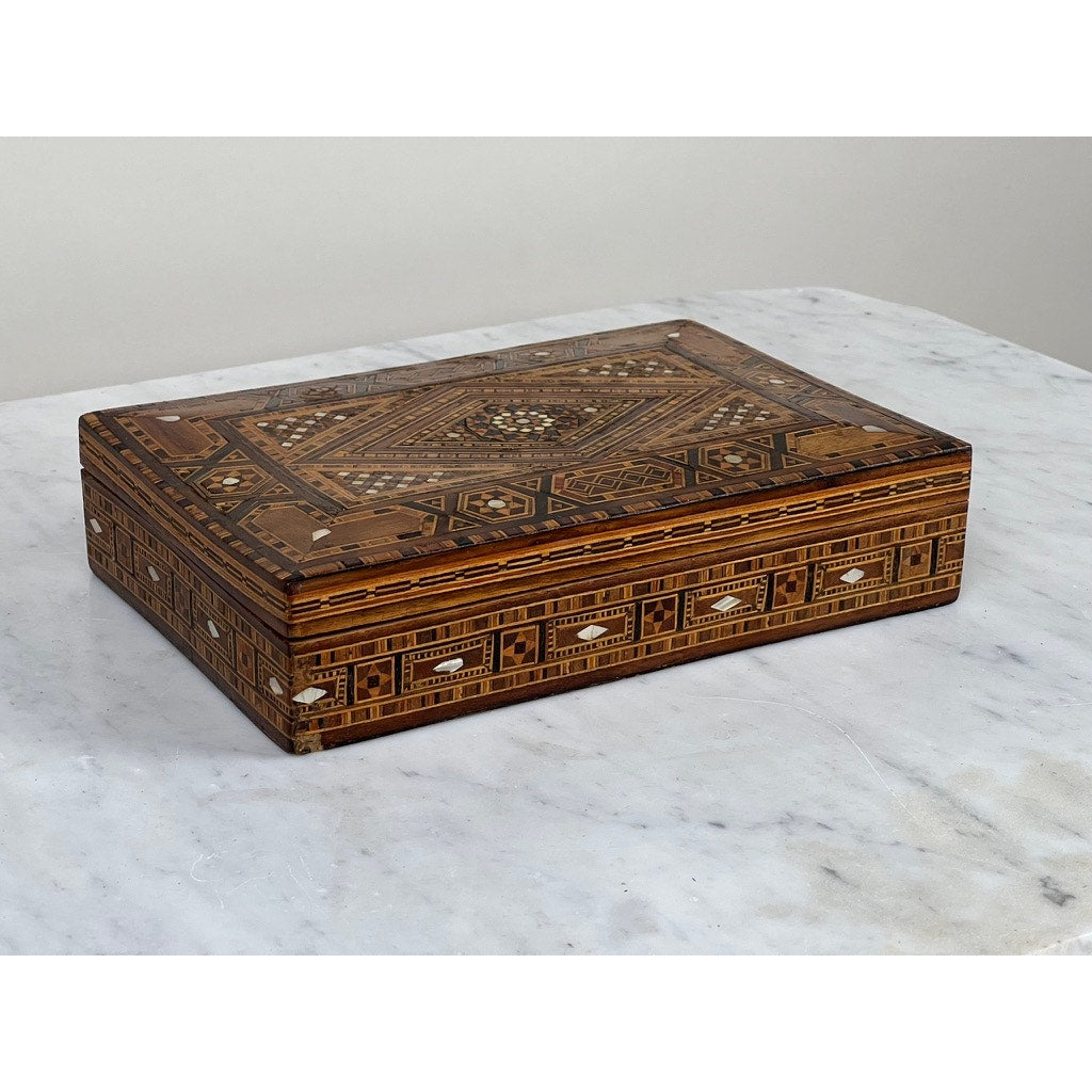 An Antique Persian (likely Syrian) Khatam wood inlaid jewelry box, early 20th century, features intricate brown and cream geometric patterns on the lid and sides, reflecting traditional Middle Eastern craftsmanship.
