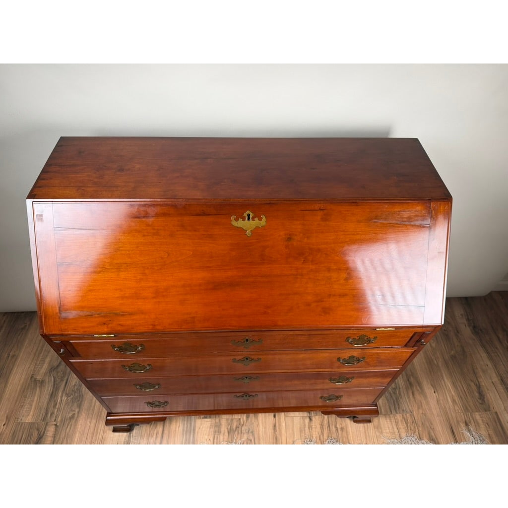 High-angle view of a Chippendale Cherry Slant-Front Desk with Ogee Bracket Feet, Possibly Connecticut River Valley, circa 1770–1790, featuring brass hardware and four drawers.