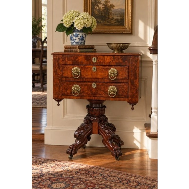 American Classical Figured Mahogany Work Table, circa 1830–1845, featuring a wooden pedestal base and two drawers accented with brass lion-head pulls.