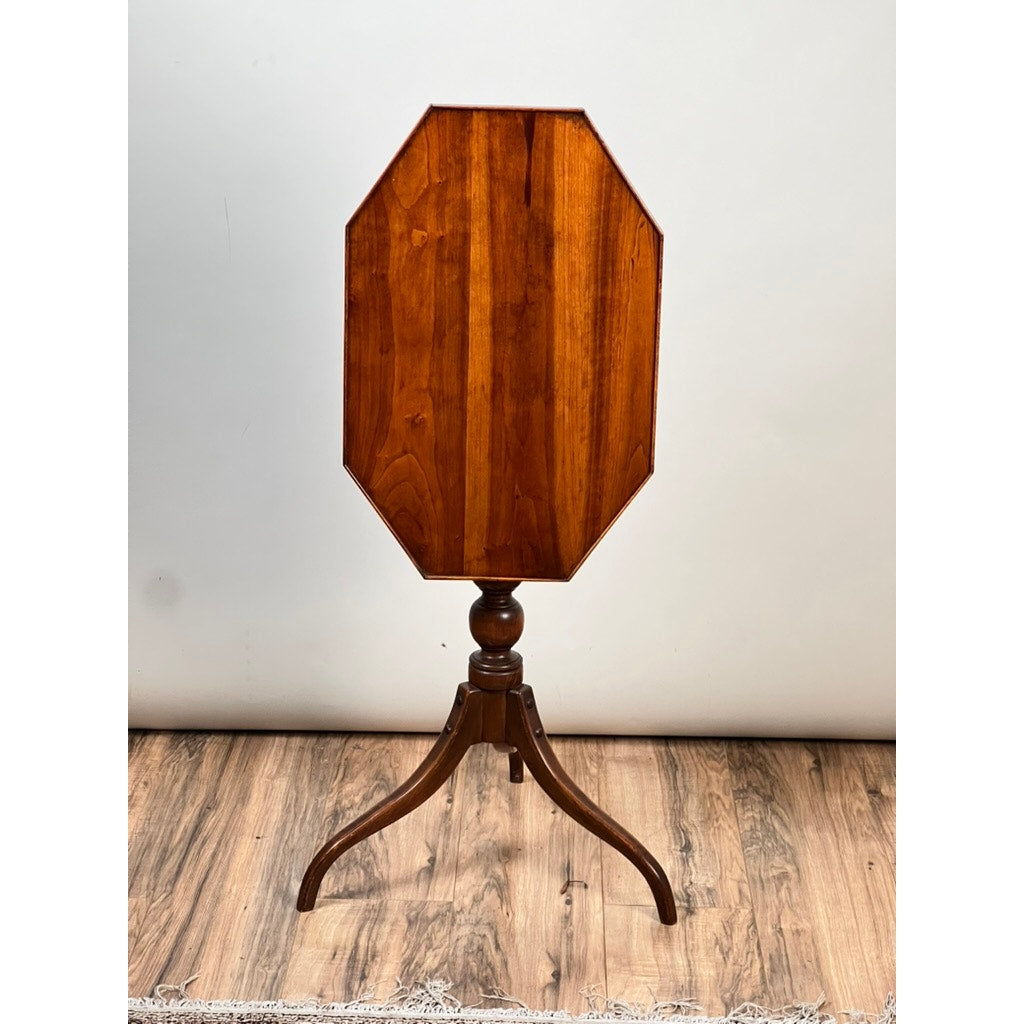 The Vintage Federal Style Cherry Octagonal Tilt Top Candlestand by Stickley features an octagonal polished top and three curved legs, shown on a wood floor with a plain light background.