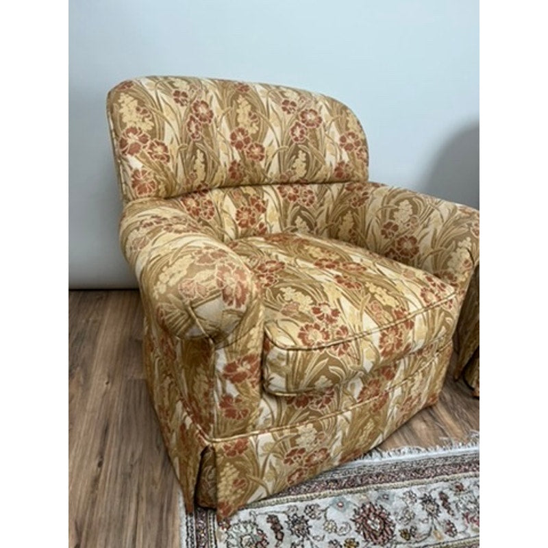 Rolled arm club chairs in warm patterned fabric with tailored skirts