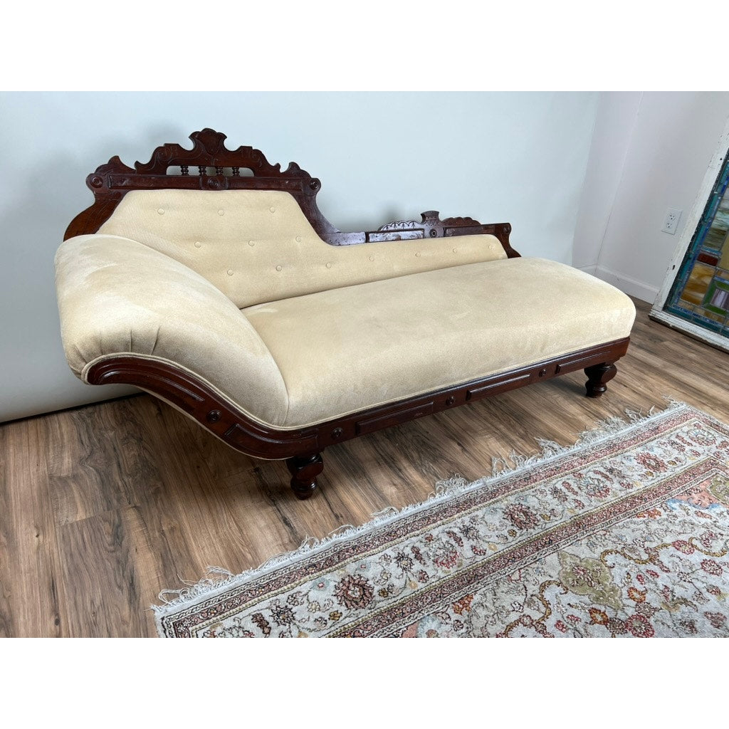 Antique Eastlake Victorian walnut fainting couch with beige upholstery