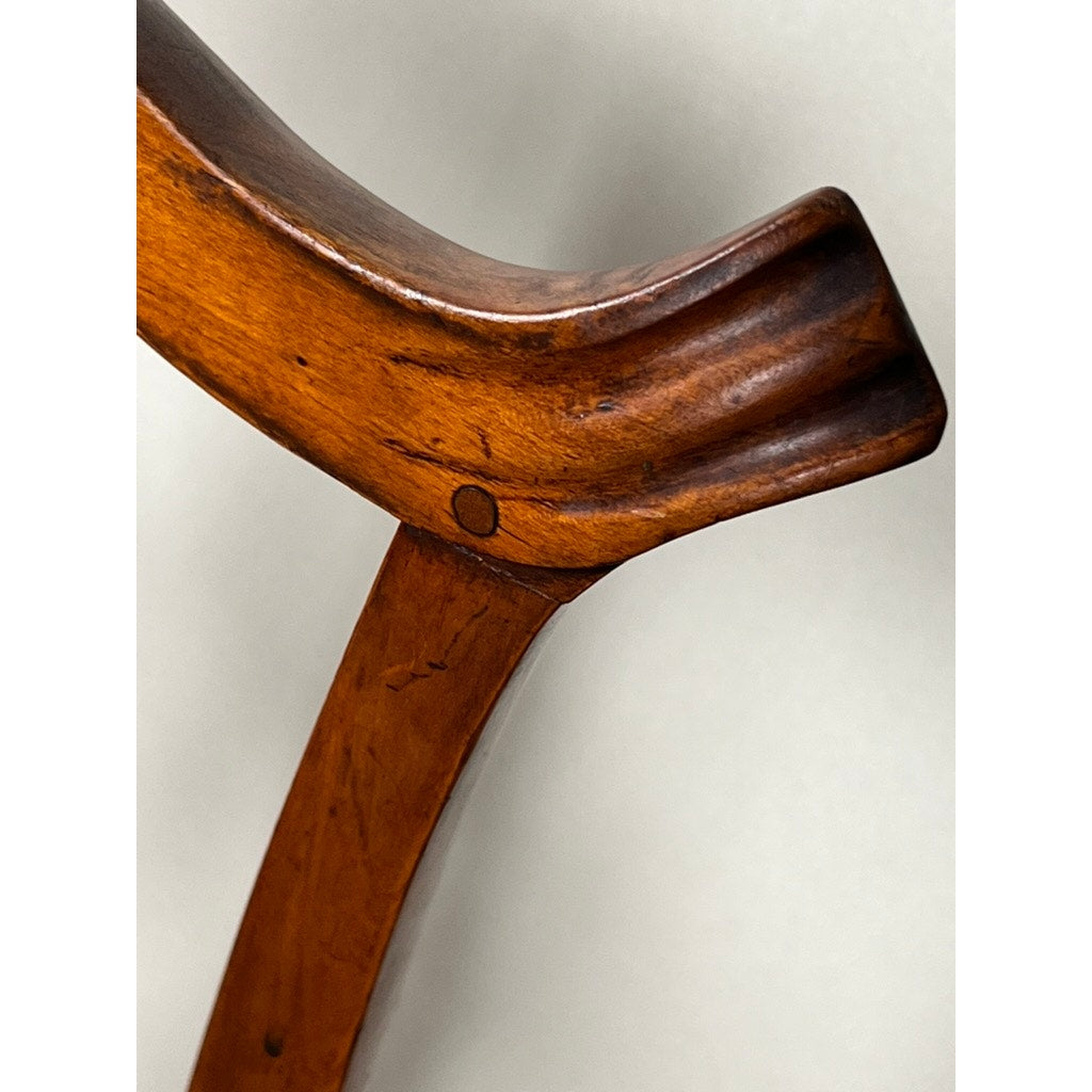 Close-up of an Antique Chippendale Side Chair with Needlepoint Seat, c. Mid 19th Century; features a curved, polished wooden backrest with smooth joints and visible wood grain, set against a plain light background. Brand: None/Unknown.