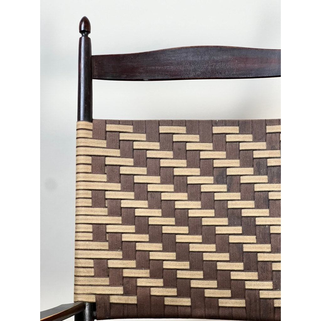 Close-up of the Antique Shaker #6 Tape Seat Rocker by Mt. Lebanon Shakers (late 19th c.), highlighting its backrest with a checkered, basket-like woven pattern of alternating light and dark brown bands. Brand: Unknown.