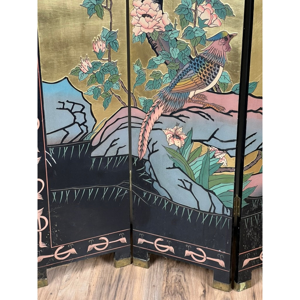 The Vintage Asian Black Lacquer Coromandel Room Screen showcases Chinese decorative art with a colorful bird perched on a rock among green leaves and pink flowers, highlighted by gold and pastel tones above a wooden floor design.