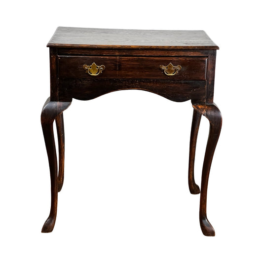 An Antique Queen Anne Style George III oak one drawer stand (late 18th century) with curved legs and a single front drawer with two brass handles, displayed against a white background.