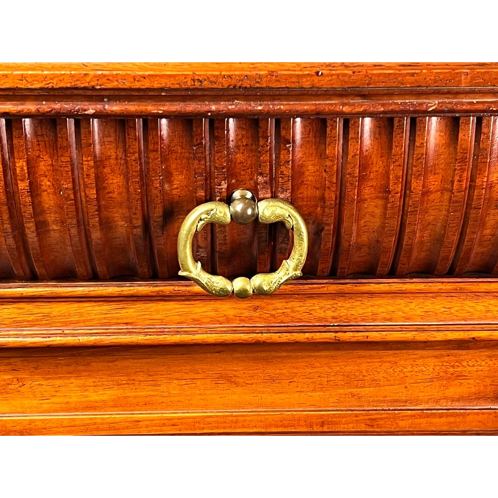 Close-up of a wooden drawer with a carved, grooved front and twin dolphin brass handle from an Antique English Jacobean Revival Mahogany Buffet c. 1915–1925, featuring elegant carved ball and claw feet. Brand: unknown.