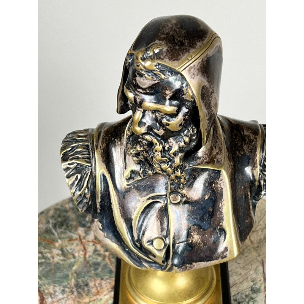 Patinated bronze sculpture of Michelangelo by Albert-Ernest Carrier-Belleuse, modeled before 1883 in Paris, featuring a hooded cloak and ornate detail, displayed on a marble surface with a gold and black base. Brand: Unknown.