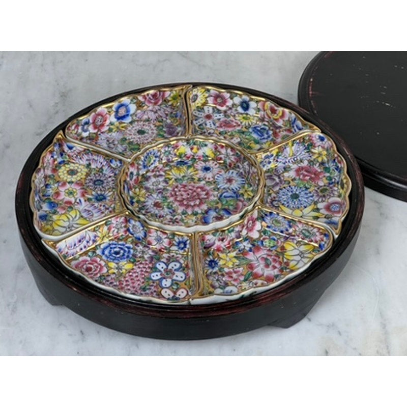 This Vintage Chinese Canton Sweet Meat Set with Case (c. Early 20th Century) includes seven porcelain sections with colorful floral designs, arranged in a wooden tray displayed on a marble surface. Brand: Unknown.