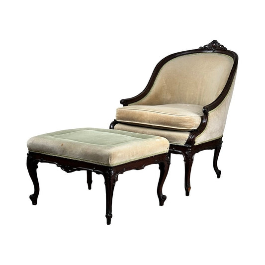 An Antique French Louis XV Style Walnut Bergere Chair with Ottoman, c. late 19th century, featuring carved walnut frames and matching upholstery. Brand: None/Unknown.