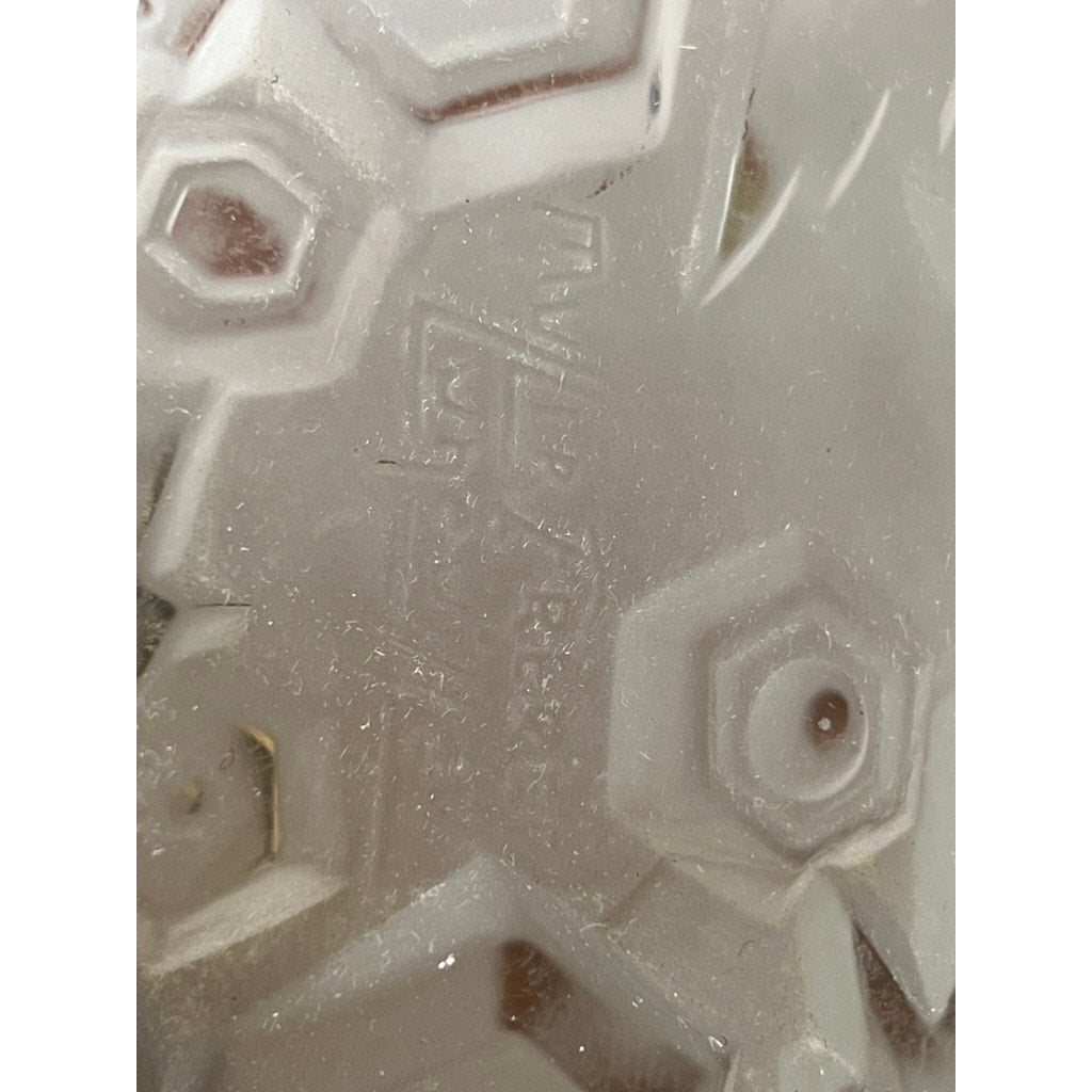 The hexagonal tread on the shoe’s sole echoes the textured frosted glass of a Vintage French Art Deco Table Lamp by Muller Frères Lunéville, c. 1920, evoking a sense of refined elegance.