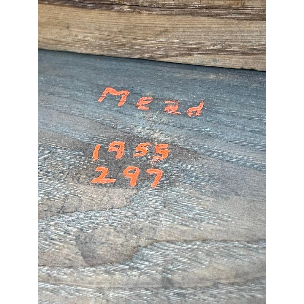 Close-up of handwriting in orange ink on wood, reading Mead 1955 297, with an old book above—possibly resting atop an Antique English William & Mary Walnut One Drawer Gateleg Dining Table from the early 18th century.