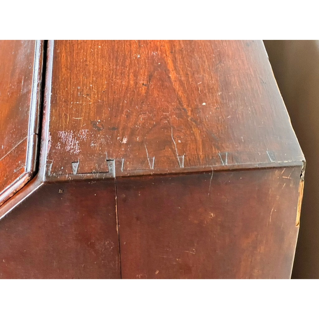 Close-up of the dovetail joints at the corner of an 18th Century New England Chippendale Cherry Slant Front Desk, Circa 1770–1790, showing visible scratches, wear, and a grain split—signs of age and use characteristic of this antique piece.