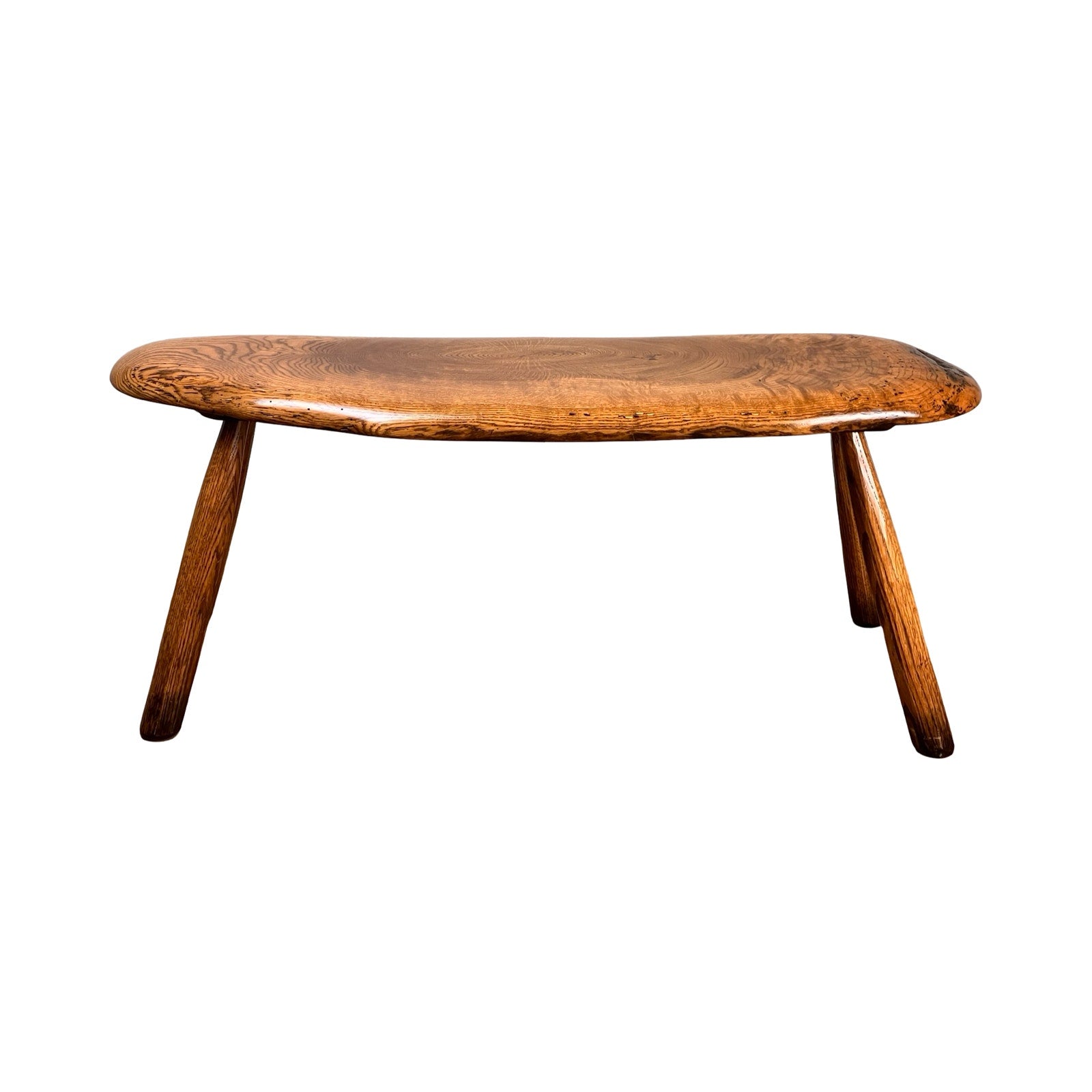 A vintage handmade oak Wabi Sabi bench, signed by Neil Panyik, features a rustic three-legged design with a curved smooth seat and angled legs, shown against a white background. Brand is unknown.