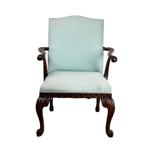 Antique George II Mahogany Gainsborough open arm chair, mid 19th century, with ornate carved mahogany frame and cabriole legs, featuring light blue upholstery on seat and backrest, shown from the front against a white background.