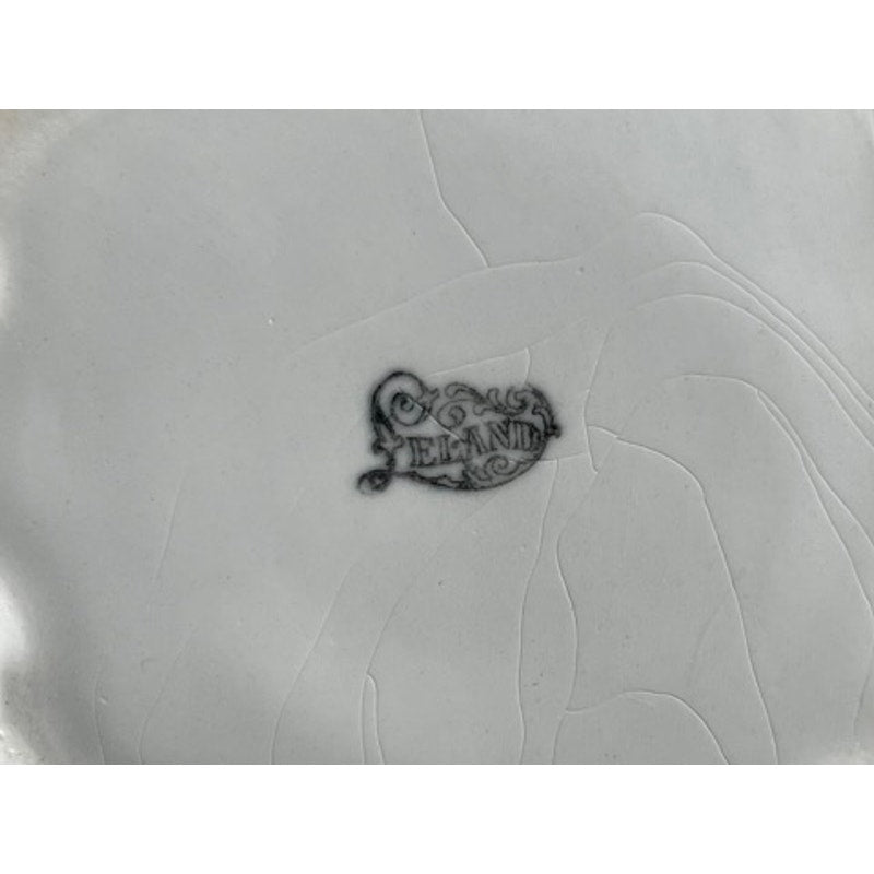 A close-up of a cracked ceramic surface with a black stamp reading "Leland," from an Antique Victorian Porcelain Wash Stand Set with Stand, signed Leland, dating to the late 19th century.