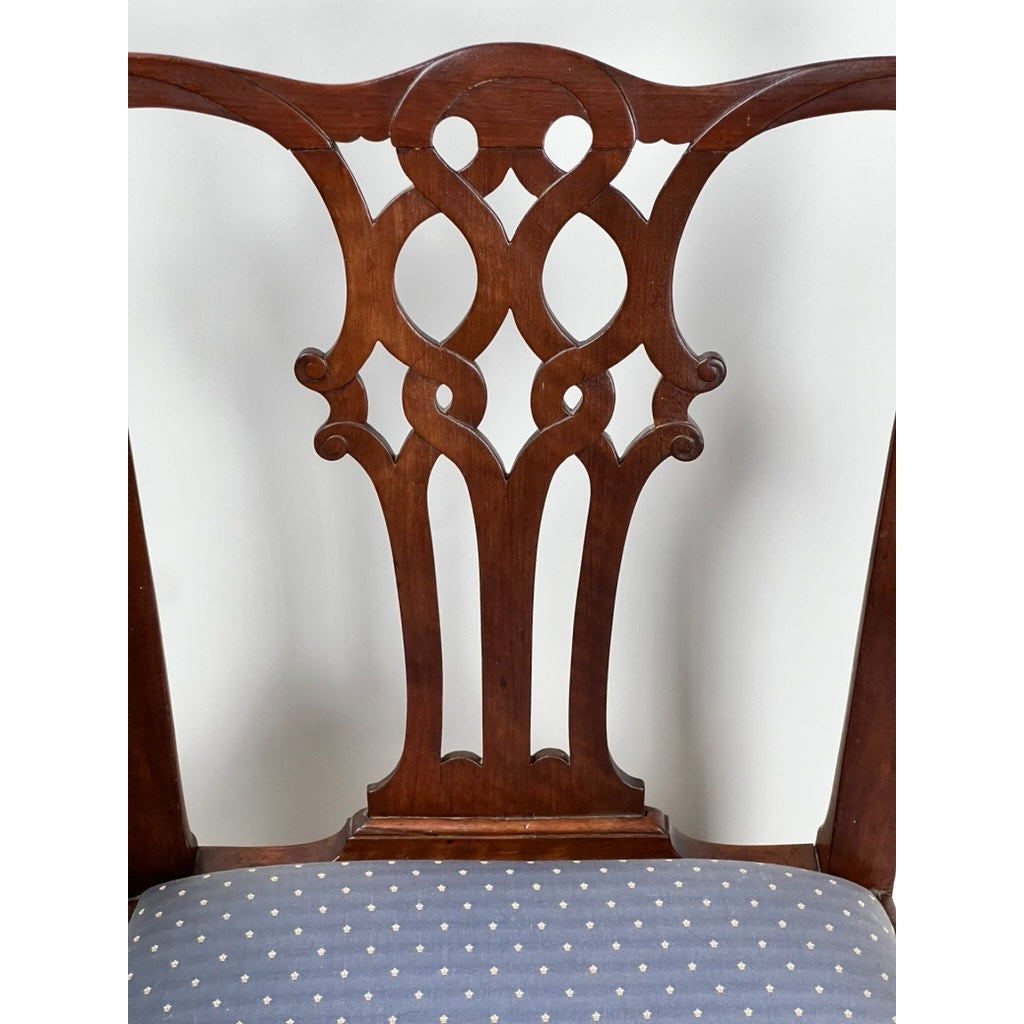 Close-up of an Antique Chippendale Walnut Open Arm Chair (late 18th century), showing its intricately carved back and blue polka-dot upholstered seat, set against a plain white background. Brand is unknown.