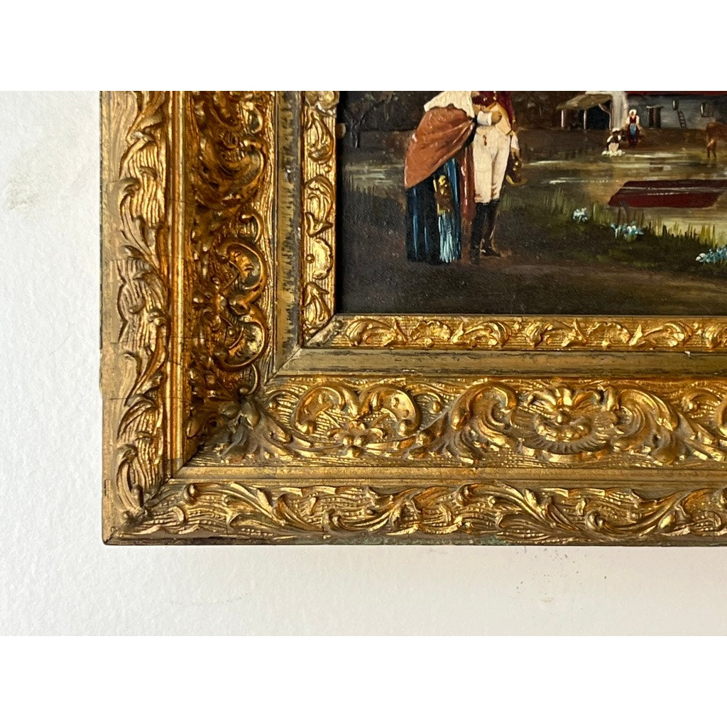 Close-up of the ornate gilt frame on this Antique Oil on Canvas Small Format Painting of a Military Officer Escorting an Old Woman (19th Century), featuring intricate floral and scrollwork designs with part of the figures visible.