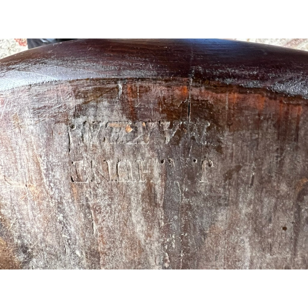 A close-up of a worn wooden surface shows faded engravings and scratches reading UNION T.P., reminiscent of early 19th-century design seen in JR Hunt’s Antique Set of Four New Hampshire Step Down Windsor Chairs.
