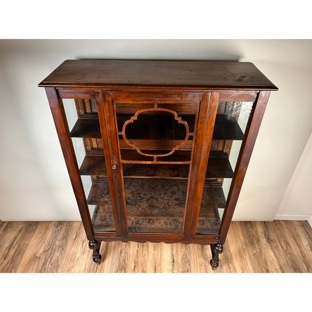 A stunning Depression Era Mahogany Curio Display Cabinet with Glass Sides, circa 1930s, this vintage American furniture piece showcases three spacious shelves behind ornate front glass doors and elegantly carved legs—an exquisite example of period craftsmanship perfect for display.