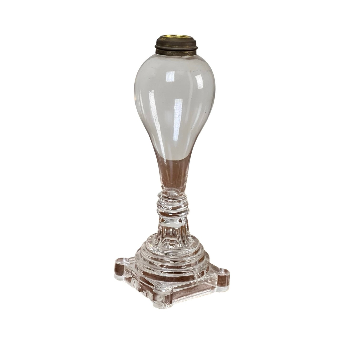 Attributed Boston & Sandwich Pressed Glass Boudoir Fluid Lamp, Circa 1850. This clear pressed glass oil lamp base showcases an ornate, tiered design, with a round bulbous upper section and a square pedestal bottom. Reminiscent of the early American mid-19th century boudoir fluid lamps, it features a brass fitting at the top for attaching a burner or chimney. Brand: None/Unknown.