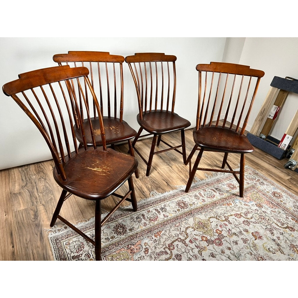 A set of four JR Hunt Antique New Hampshire Step Down Windsor Chairs (early 19th century) is displayed on a patterned rug over wood floors; one chair has visible surface scratches.