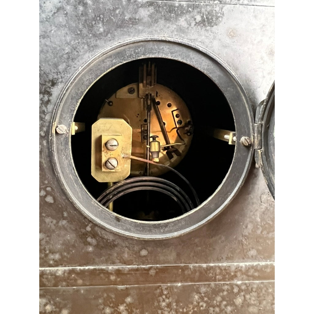 Close-up of the Antique Victorian Slate Mantle Clock with Open Escapement 8 Day Time and Strike (late 19th century), showing its aged interior gears and wires through a hinged door set in a worn black slate frame. Brand: unknown.