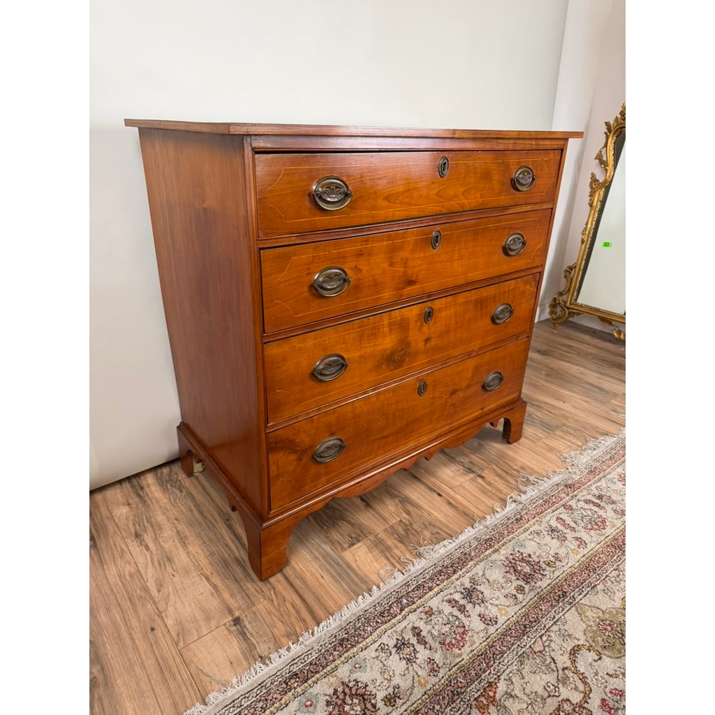 Pennsylvania Federal Cherry Four-Drawer Chest with Satinwood String Inlay featuring brass pulls and a scalloped base.