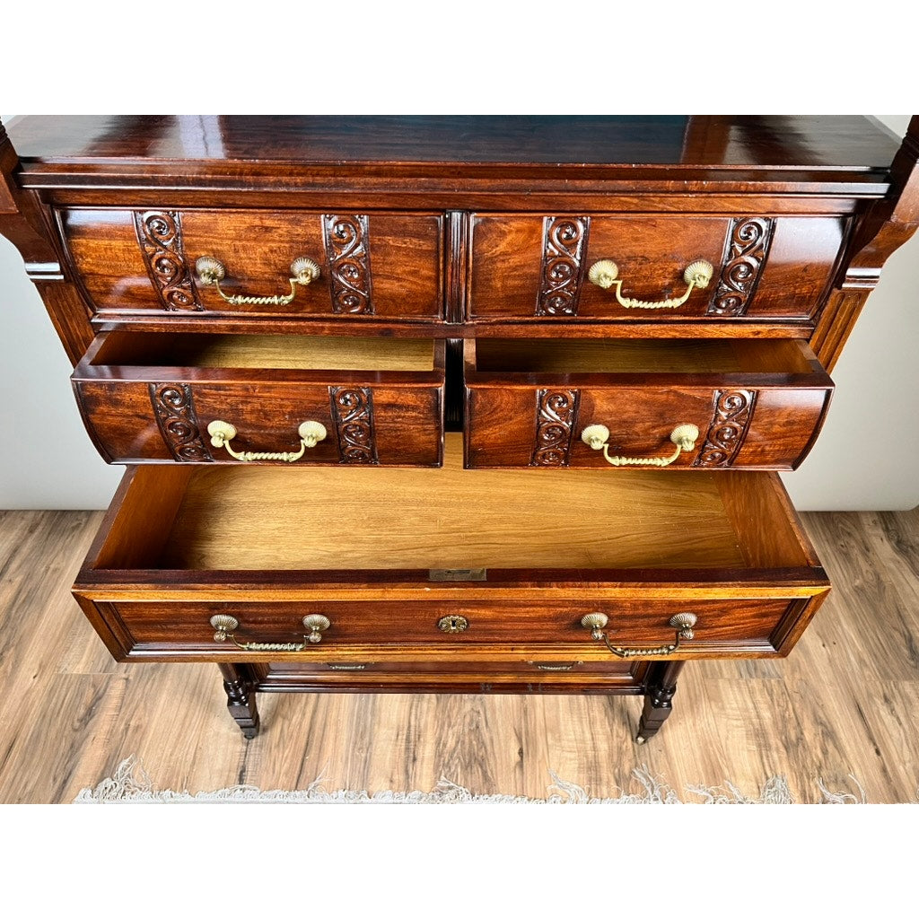 An Antique Victorian Aesthetic Movement Mahogany Four Over Four Gentlemen’s Chest c. 1880 stands on a wooden floor with part of a light rug below, its open drawers and classic design evoking timeless elegance. Brand: None/Unknown.