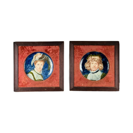 Antique pair of framed portrait plates by Haviland Co Limoges France, mid-19th century, featuring painted ceramic plaques: a woman in a feathered hat and a man with curly hair, each on a blue background in dark wood frames.