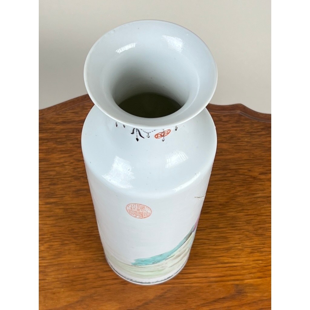 An Antique Qing Dynasty Famille Rose 12” Vase with Qianlong Mark, featuring a wide flared opening and subtle painted details near the neck, is displayed on a wooden surface. Brand: None/Unknown.