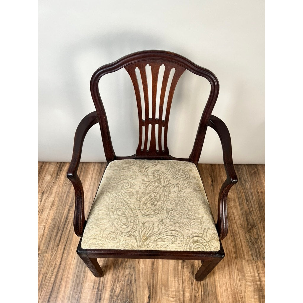 Antique English George III Mahogany Hepplewhite armchair, early 19th century, features a decorative splat back, curved arms, and a cushioned seat in light paisley fabric. Shown on a wood floor against a light-colored wall. Brand unknown.