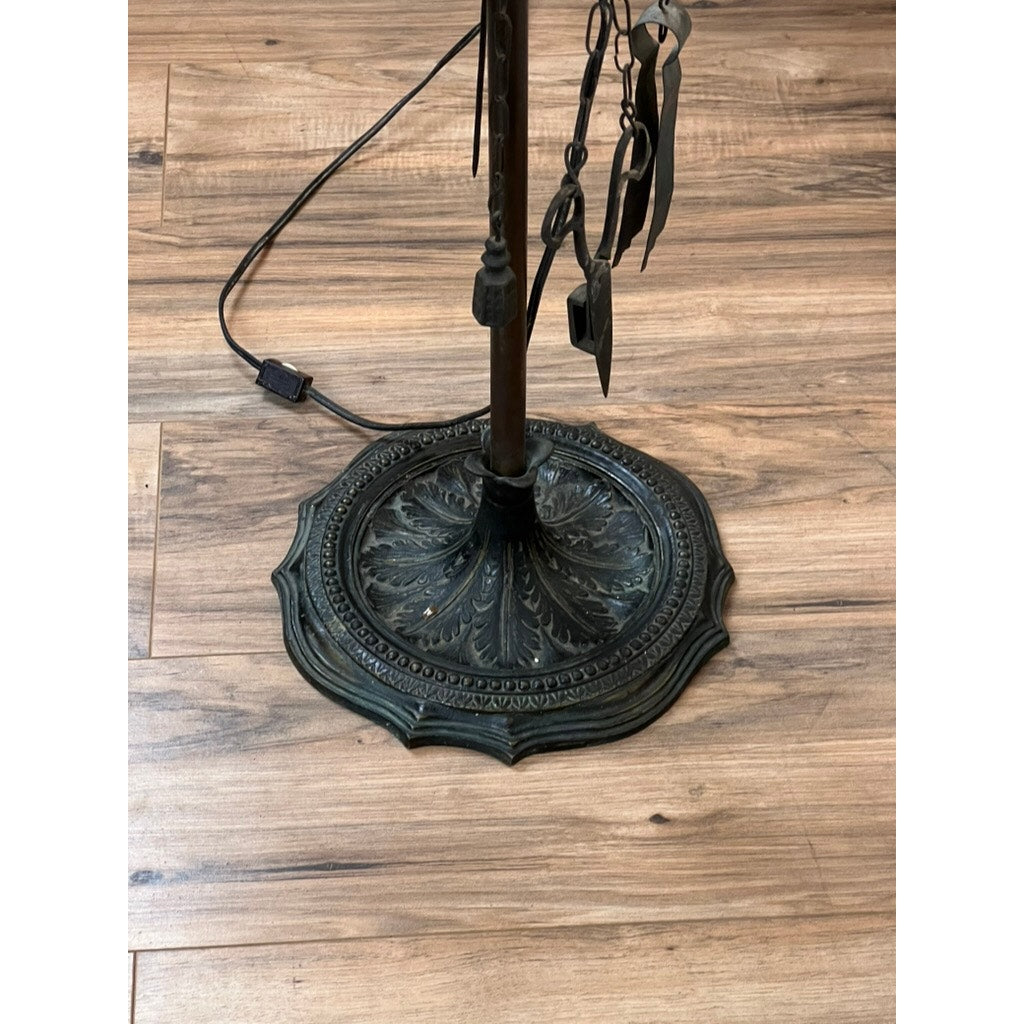 An Antique Five Burner Lucerne Whale Oil Lamp with a Napoleon I Fireplace Screen Shade and ornate leaf patterns stands on a wooden floor, with its electrical cord and switch visible beside the base. Brand: Unknown.