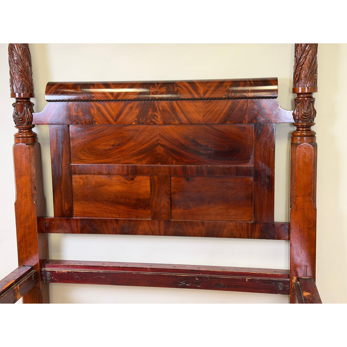 American Classical Carved Mahogany Four-Poster Tester Bed, possibly New York, circa 1825–1840, featuring a headboard with a curved top rail and carved wooden columns.