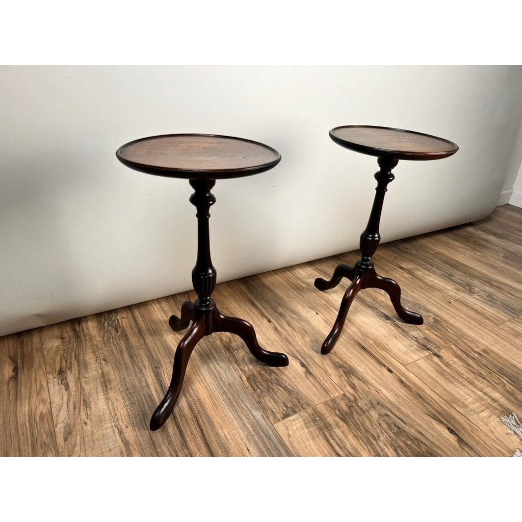 A pair of vintage Match Pair Diminutive Walnut Candle Stands from c. 1940, each with three curved legs and dark walnut finish, displayed side by side on a wood floor against a plain white wall.