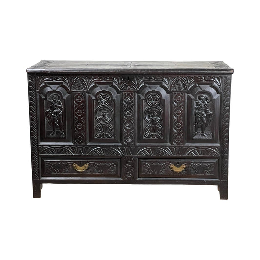 An Antique 18th Century Charles II Style Mule Chest—possibly Irish or Scottish—with ornate carved human figures and floral patterns on dark wood, featuring two lower drawers with brass handles; a rare, exquisite piece.