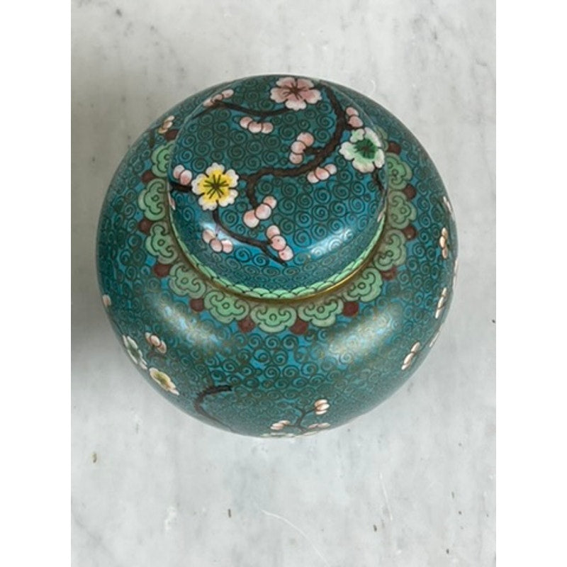 A vintage pair of Chinese cloisonné ginger jars, featuring round teal-blue ceramic bodies with lids and intricate floral and swirl designs, make an elegant decorative accent inspired by classic Chinese style.