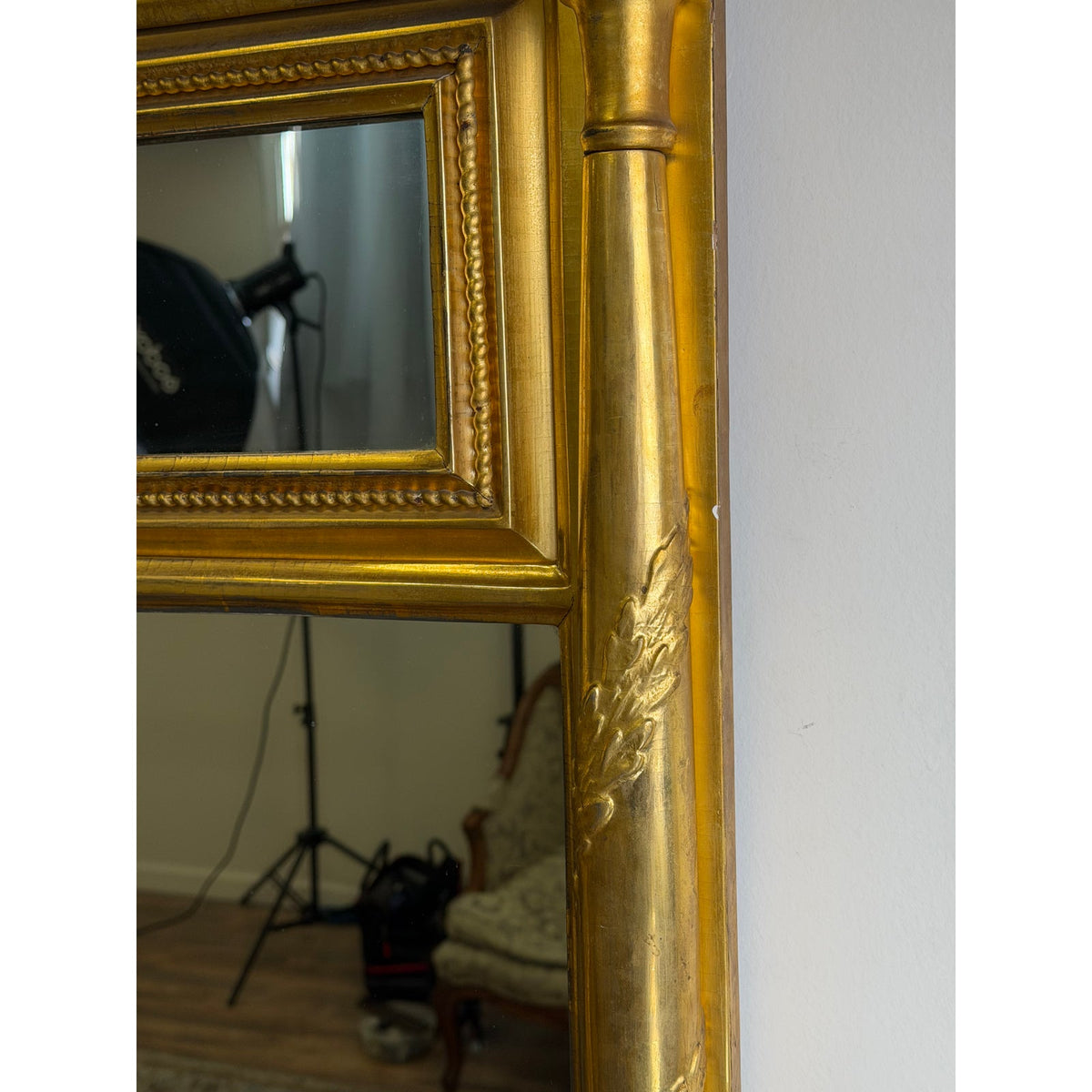 Close-up of an American Federal Giltwood Two-Plate Looking Glass, Probably Massachusetts, circa 1810–1830, featuring a gold-toned neoclassical frame with a beaded inner border and a side column with carved leaf detailing.