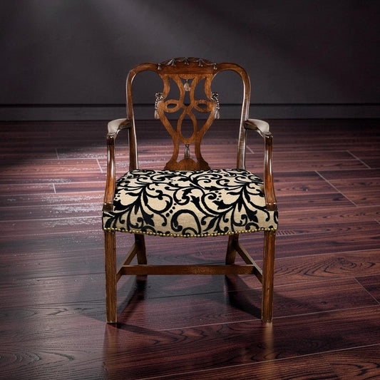 The Antique George III Chippendale Open Arm Chair c. Early 19th Century by Pearl City Antiques features an intricate backrest and a beige cushion adorned with a bold black floral pattern, capturing the timeless elegance of antique English furniture as it sits gracefully on a polished dark wood floor.